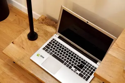 a laptop computer sitting on top of a wooden table at Termini Terrace in Rome
