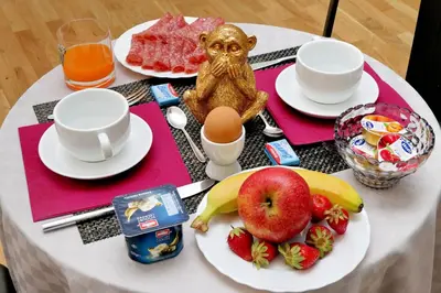 a table with a breakfast of eggs and fruit at Termini Terrace in Rome