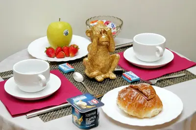 a table with plates of food and cups and a pastry at Termini Terrace in Rome
