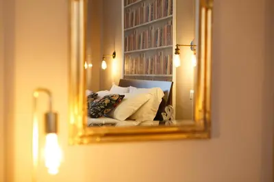 a light on a wall next to a mirror at A Casa di Leonardo II in Rome