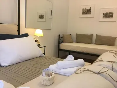 a room with two beds with towels on them at LE FATE SUITES in Rome