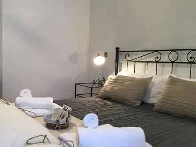 a bedroom with a bed with towels on it at LE FATE SUITES in Rome