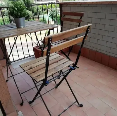 a wooden bench sitting next to a picnic table at RomAmoR in Rome