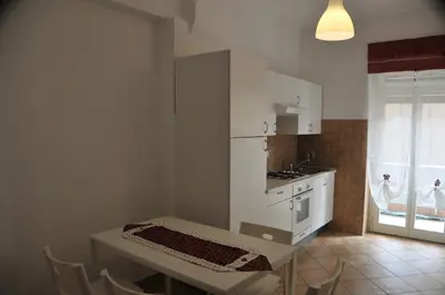 a kitchen with a table and a sink and a stove at RomAmoR in Rome