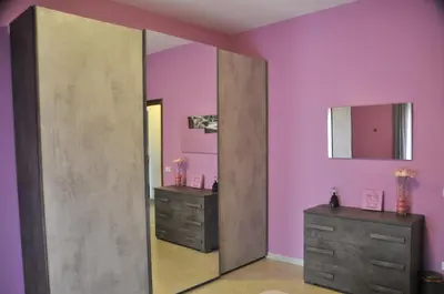 a pink bathroom with two dressers and a mirror at RomAmoR in Rome
