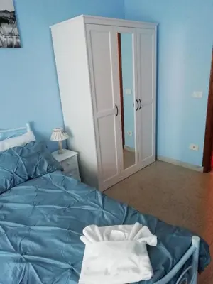a bedroom with a bed and a door with a mirror at RomAmoR in Rome