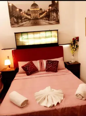 a bedroom with a large bed with two towels on it at affittacamere sereno in Rome