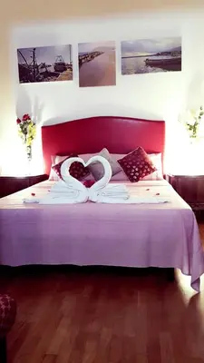 a bedroom with a bed with a heart pillow on it at affittacamere sereno in Rome