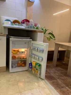 a small refrigerator with its door open in a kitchen at affittacamere sereno in Rome