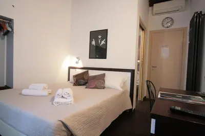 a bedroom with a bed with towels on it at House Monti 1875 in Rome
