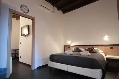 a bedroom with a bed and a clock on the wall at House Monti 1875 in Rome
