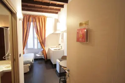 a room with a room with a bed and a sink at House Monti 1875 in Rome