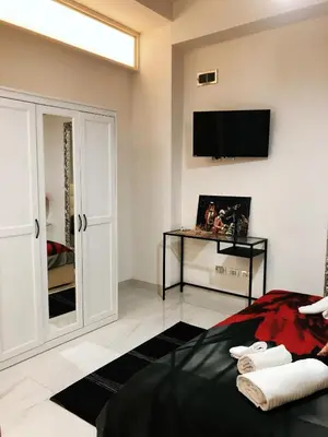a bedroom with a bed and a tv on the wall at Spagna Gregoriana 46 in Rome