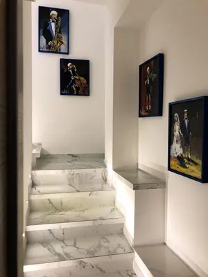 a set of stairs in a museum with paintings at Spagna Gregoriana 46 in Rome