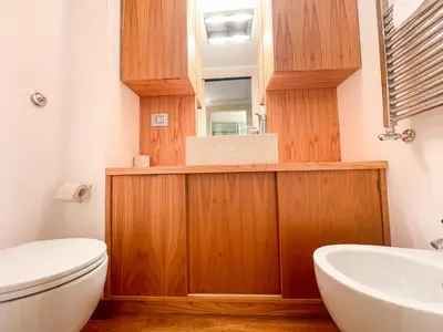 a bathroom with a toilet and a sink and a mirror at La Pigna Boutique Apartment in Rome