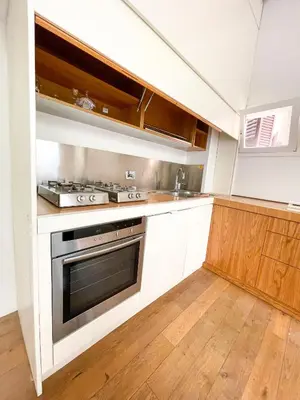 a kitchen with white cabinets and a stove top oven at La Pigna Boutique Apartment in Rome
