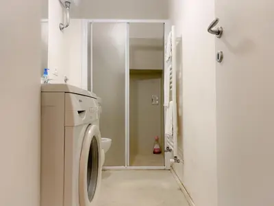 a washing machine in a bathroom with a mirror at La Pigna Boutique Apartment in Rome