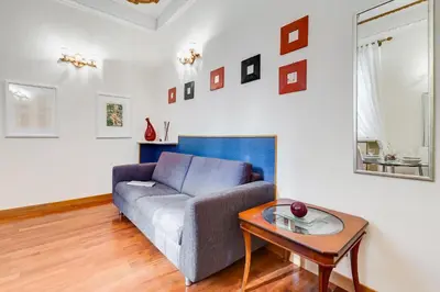 a living room with a couch and a table at Elegant Apartment Rome in Rome