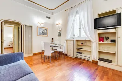 a living room with a blue couch and a table at Elegant Apartment Rome in Rome
