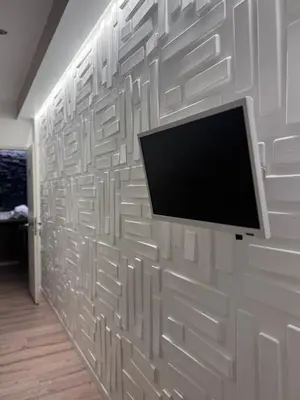 a wall with a flat screen tv on it at Living in Rome