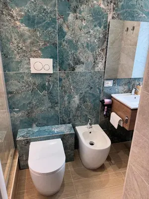 a bathroom with a toilet and a sink at Living in Rome