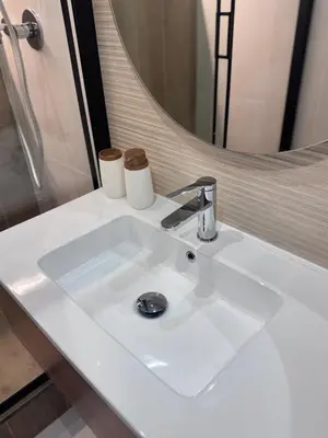a white bathroom sink with two toilets on it at Living in Rome