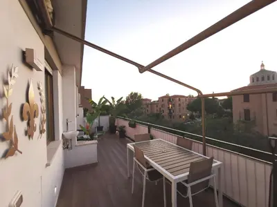 a balcony with a wooden table and chairs on it at Giglio Luxury Apartment - Romantic Jacuzzi in Rome