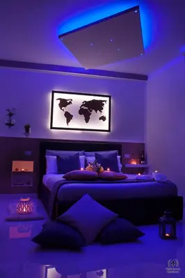 a bedroom with two beds with purple lighting at Giglio Luxury Apartment - Romantic Jacuzzi in Rome