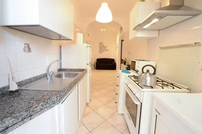 a kitchen with a sink and a stove top oven at GiuMa Roma Vatican Apartment in Rome