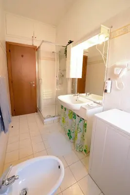 a bathroom with a tub and a sink and a mirror at GiuMa Roma Vatican Apartment in Rome