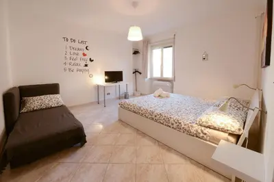 a bedroom with a bed and a chair in it at GiuMa Roma Vatican Apartment in Rome