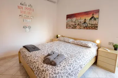 a bedroom with a bed with two towels on it at GiuMa Roma Vatican Apartment in Rome
