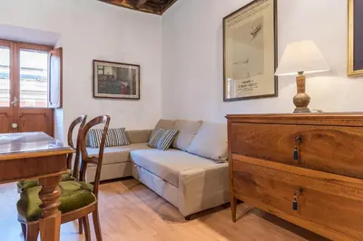 a living room with a couch and a table at GuestHost - Montecitorio & Pantheon Stylish Flat in Rome