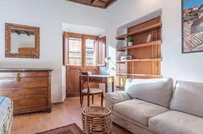 a living room with a couch and a table at GuestHost - Montecitorio & Pantheon Stylish Flat in Rome