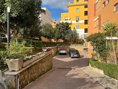 a street with cars parked on the side of the road at La Casa di Nazareth in Rome
