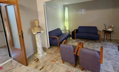 a room with a statue of a man on a pedestal at La Casa di Nazareth in Rome