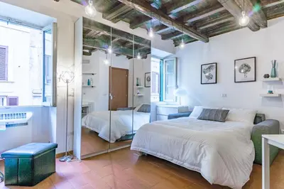 a bedroom with a large bed and a mirror at Urbana Coliseum House in Rome