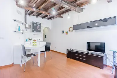 a kitchen and dining room with a table and chairs at Urbana Coliseum House in Rome