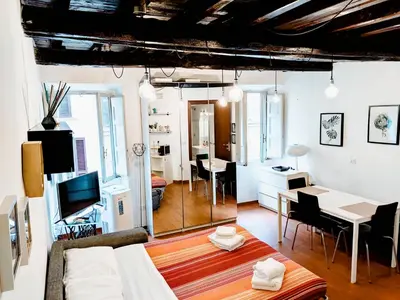 a living room with a table and a dining room at Urbana Coliseum House in Rome