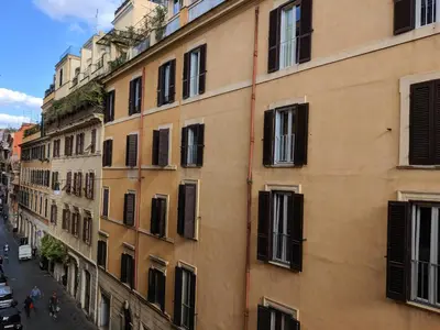 a tall building with black windows on a street at Urbana Coliseum House in Rome