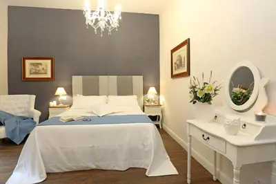 a bedroom with a bed and a mirror and a chandelier at Daplace - Arena House in Rome