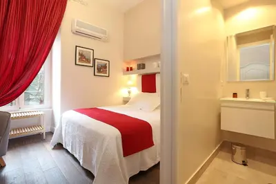 a bedroom with a bed with a red blanket at Daplace - Arena House in Rome