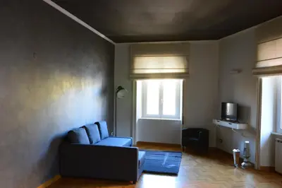 a living room with a couch and a window at Una finestra su Castel Sant'Angelo in Rome
