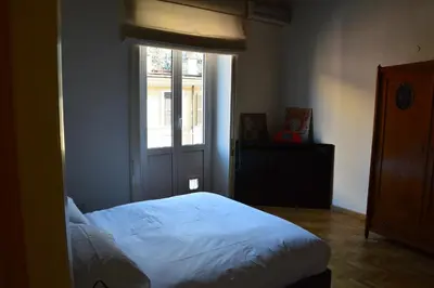 a bedroom with a bed in front of a window at Una finestra su Castel Sant'Angelo in Rome