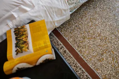a box of food on the floor next to a counter at Lo Sguardo sui Re in Rome
