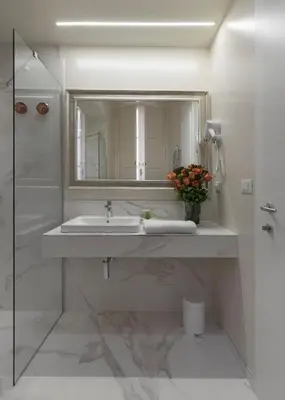 a white bathroom with a sink and a mirror at Cavour Suites Guest House in Rome