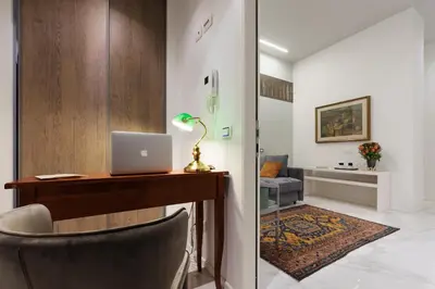 a room with a desk with a laptop on it at Cavour Suites Guest House in Rome