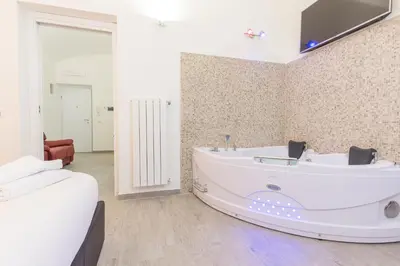a large white bath tub in a room at Suite House Vaticano in Rome