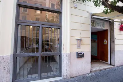 a store front with glass doors on a building at Suite House Vaticano in Rome