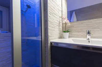 a bathroom with a sink and a shower at Suite House Vaticano in Rome